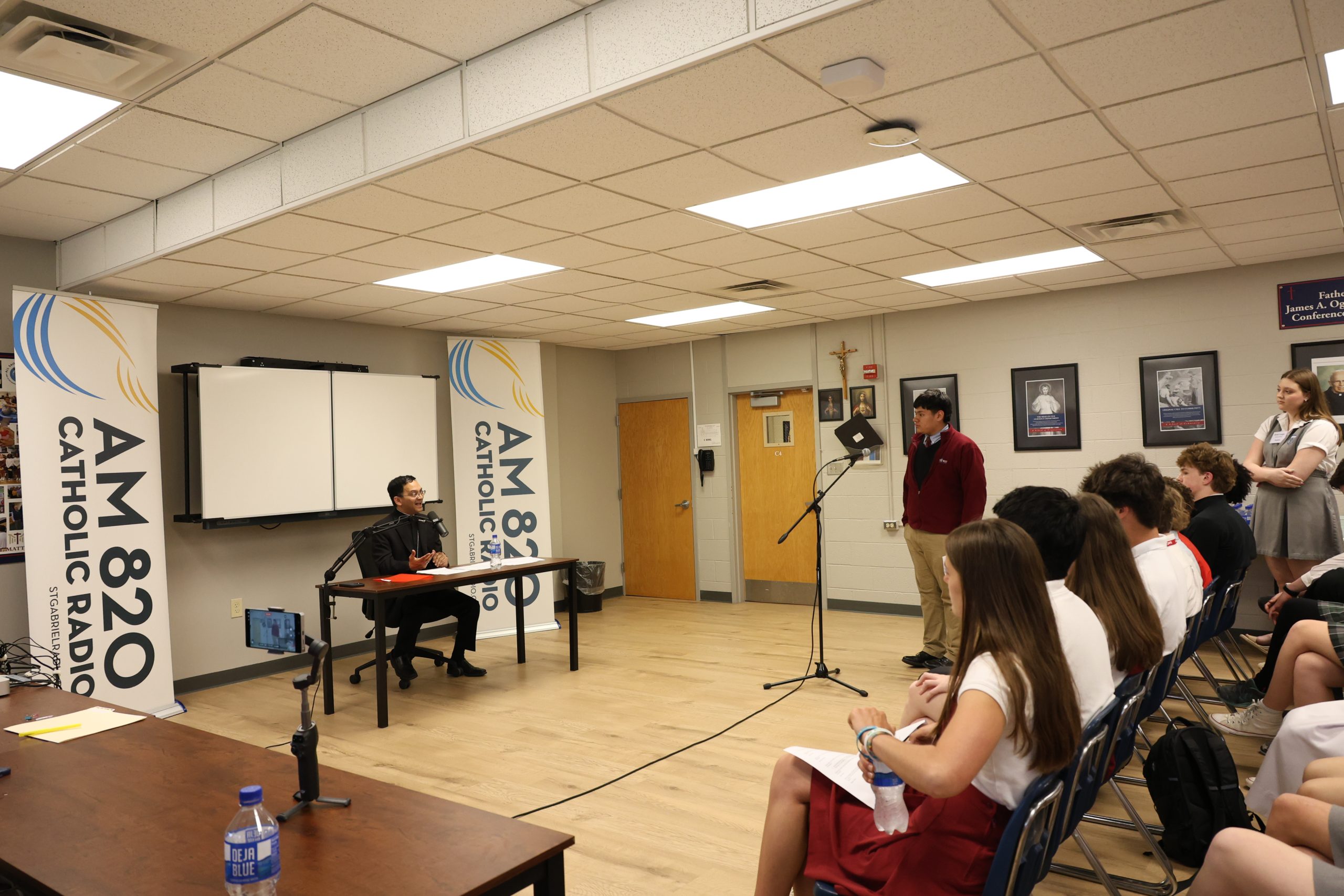 Students pepper bishop with questions during radio forum